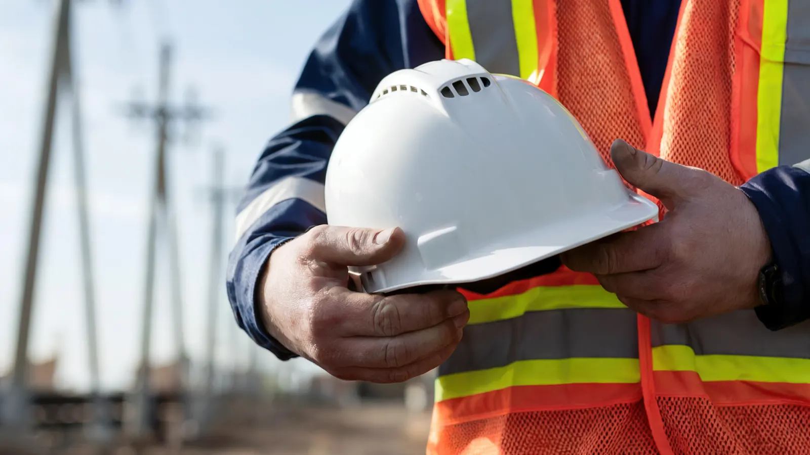 Site worker in hi-vis and a colleague shaking hands on a building site